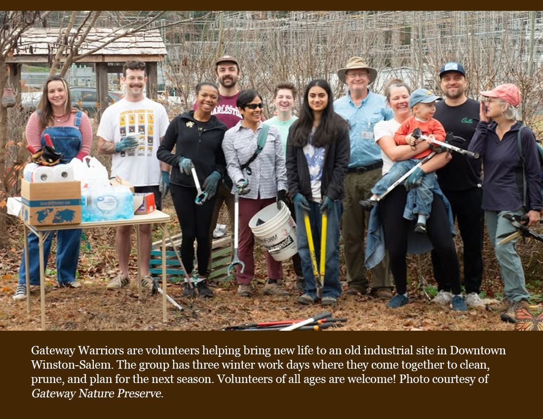 A group of volunteers standing outdoors in bare winter trees, holding gardening tools and standing next to a table with supplies. A large text banner overlays the bottom of the photo.