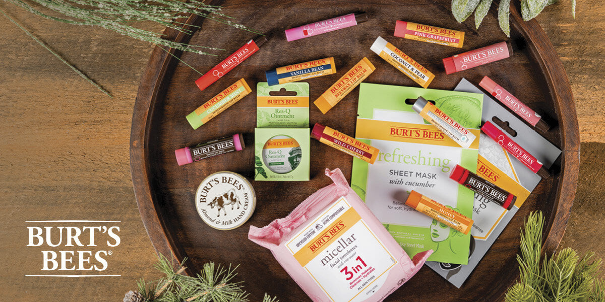 Burt's Bees skincare products on a wooden tray with greenery