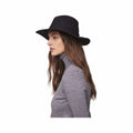 Woman wearing a stylish black felt hat with a wide brim, paired with a gray turtleneck sweater, showcasing an elegant and casual look.