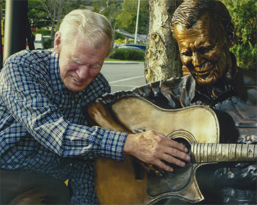 Doc Watson with the newly-installed Doc Watson Statue in Downtown Boone - Photo by Tom Fotta