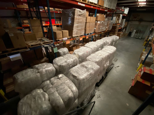 Pallets of plastic packaging awaiting pickup.