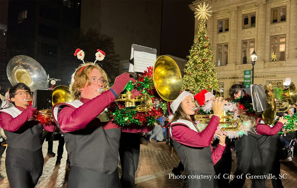 A marching band makes its way down Main Street as a part of Greenville Poinsettia Parade