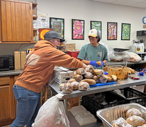 McKenzie and Sammy make sandwiches in the kitchen at Hunger & Health Coalition