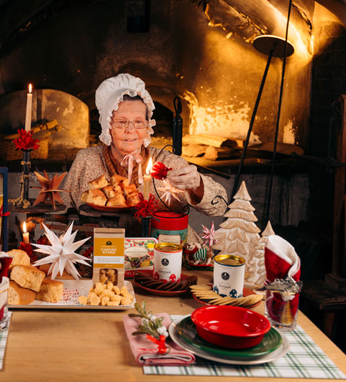Sister Deborah lights a candle near the oven at the Winkler Bakery in Old Salem