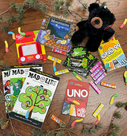 Stocking Stuffers for kids including a pocket-size Etch-a-Sketch, stuffed animal, and UNO cards